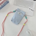 Detailed view of checkered mini mobile bag with contrast colorful rope strap and brand tag - Light Blue Plaid