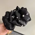 Dettaglio della grande pinza per capelli a fiore in rete nera con eleganti perle - Elegante Molletta con Perle Nere