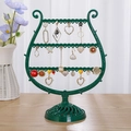 Green harp-shaped earring organizer with vintage scroll design and round base - Dark Green