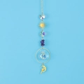 Detail of golden suncatcher with purple stones, crystal ball and crescent moon fairy pendant - Amethyst