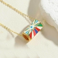 Detail shot of golden necklace with cylindrical enamel evil eye pendant on beige stone - Multicolor Pendant (XL2685-7)