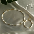 Elegant pearl and gold bead necklace and bracelet set on silk fabric with green leaves - Set - Alternating Pearl & Gold Bead