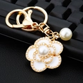 Golden camellia flower keychain with white enamel and artificial pearls on a bag charm - White Pearl Camellia