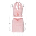 Detailed front view of pink halter twist top and matching ruffled mini skirt set on mannequin - S / Pink