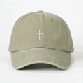Close-up of cross embroidery and washed cotton texture on khaki baseball cap - Khaki