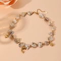 Close-up of shell beads necklace with gold dolphin, turtle and starfish pendants - Dolphin Necklace