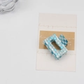 Checkerboard pattern hair claw clip with blue and white mosaic design on white background - Blue White Plaid