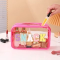 Detail of transparent PVC toiletry bag showing colorful glitter SNACK letter patches - Rose Red (SNACK)