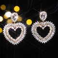 Luxury heart-shaped gold drop earrings with clear sparkling zircon and bokeh background - White Heart