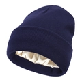 Close-up of the satin lining inside a navy knit beanie designed for hair protection - Navy Blue