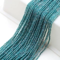 Vista macro di perle di cristallo sfaccettate da 2mm blu petrolio per gioielli DIY - Blu Pavone Nuovo AB