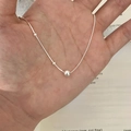 Detailed close-up of a silver butterfly pearl necklace held in hand for scale - Bead and Thin Bar Design Necklace (XL3177)
