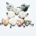 Collection of heart-shaped natural stone pendants with diverse colors and metal loops - Crazy Agate
