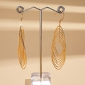 Detail of gold layered teardrop earrings with textured finish on a metal display stand - Earring Hooks / Gold