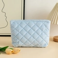 Detail of light blue quilted corduroy makeup bag with metal zipper in a cozy setting - 27x6.5x17.5cm / Corduroy Blue