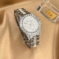 Detailed macro view of silver luxury watch with diamond-set bezel on silk background - Silver