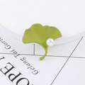 Elegant green ginkgo leaf brooch with white pearl detail on minimalist white stand - Matte Grass Green With Pearl Style (C2071-1)
