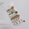 Golden hair clip set with pearls, green gems, and daisies on a display card - Luxury Heavy Craft 8-Piece Set