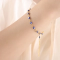 Gold evil eye bracelet with blue and white beads and adjustable chain on wrist - Dark Blue Bracelet