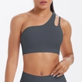 Detail view of dark grey sports bra with asymmetrical one-shoulder strap design - Graphite Grey