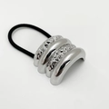 Close-up of minimalist silver metallic shell hair tie with textured finish and black band - Hammered Texture Four-section / Silver