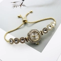 Close-up of gold women watch with rhinestone bezel and adjustable slider chain bracelet - Gold White