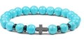 Detail of blue turquoise beads with black cross charm and hematite spacers on bracelet - Turquoise