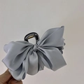 Detail showing high-end silver grey satin bow texture on the premium hair claw clip - Large Bowknot / Fog Blue