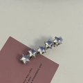 Detail view of silver hair clips featuring five pointed stars with aurora crystal inlay - Silver/White Zirconia-Five Stars