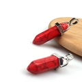 Red natural stone hexagonal prism pendants with silver metal clasp on wooden base - Red Howlite