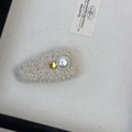 Detail view of a cream faux fur hair clip featuring a large pearl and gold metal accent - Hair Clip / Off White