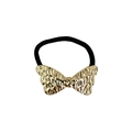Macro detail of golden hammered bow hair tie with high-elasticity black braided band - Hammered Texture Bow