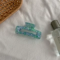Detailed view of medium marbled acetate hair claw clip with blue and green patterns - Medium Square Claw / Floral Green
