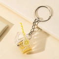 Luminous fruit milk tea cup keychain with yellow flower pattern and liquid glitter - Yellow