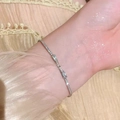 Elegant silver bow bracelet with sparkling zircons worn on a female wrist - S367 Silver