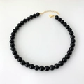 Detailed view of black onyx beaded necklace with gold lobster clasp and extension chain - 10mm Round Bead Necklace