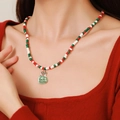 Christmas necklace with red, green and white beads featuring a green gift bag charm - D1220 Single Layer Beaded Green Lucky Bag Pendant