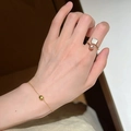 Elegant gold butterfly ring with pearl and fan-shaped shell detail on hand - Pink Pearl Fan