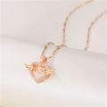 Rose gold angel wing heart necklace with sparkling diamonds on beige fabric background - Lips Chain / Rose Gold