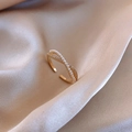 Adjustable golden crossover ring featuring elegant rows of pearls and cubic zirconia - Intertwined Pearl