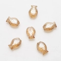 Close-up of amber fish-shaped beads with wave texture for DIY jewelry making - Amber Gold