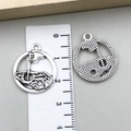 Detailed macro view showing a 2cm vintage silver golf charm with number 18 and scale ruler - 18th Hole Golf Flag