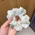 White organza scrunchie featuring light green heart patterns and a shimmering finish - Green Heart