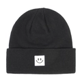 Close-up of black knitted beanie featuring a white square patch with a grey smiley face - Black