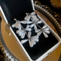 Detail view of water drop pearl cluster earrings on black velvet in a mirrored tray - Teardrop Simulated Pearl Cluster / 19# Silver-White