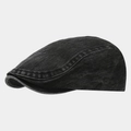 Detailed view of washed black denim texture and neat stitching on a vintage flat cap - Black
