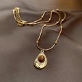 Close-up of a vintage teardrop pendant with a brown tiger eye stone on a gold snake chain - Embossed Water Drop Style (20#) / Gold