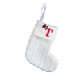 Detailed view of white knitted Christmas stocking with red embroidered letter T and mini hat - Letter T