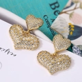 Gold-plated heart drop earrings featuring micro-pave cubic zirconia on an elegant background - Gold Pave Double Heart