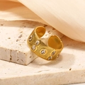 Detailed view of gold plated titanium ring with colored zircons on stone and silk background - Adjustable Open / Gold White Zirconia